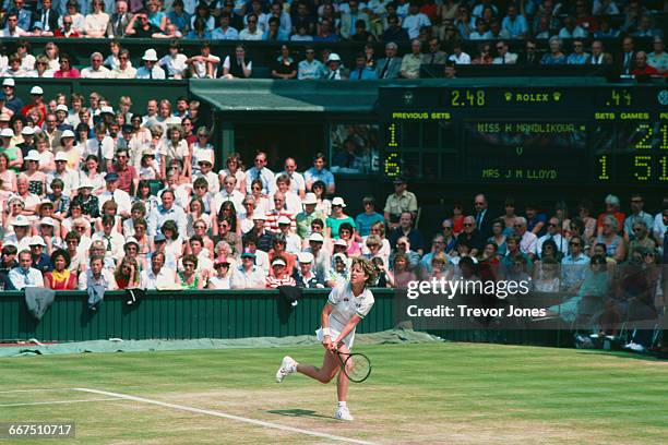 American tennis player Chris Evert-Lloyd competing against Hana Mandlíková in the semifinal of the Women's Singles at The Championships, Wimbledon,...