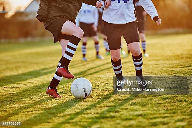 close up of female footballers footwork - adult woman legs close up stock-fotos und bilder