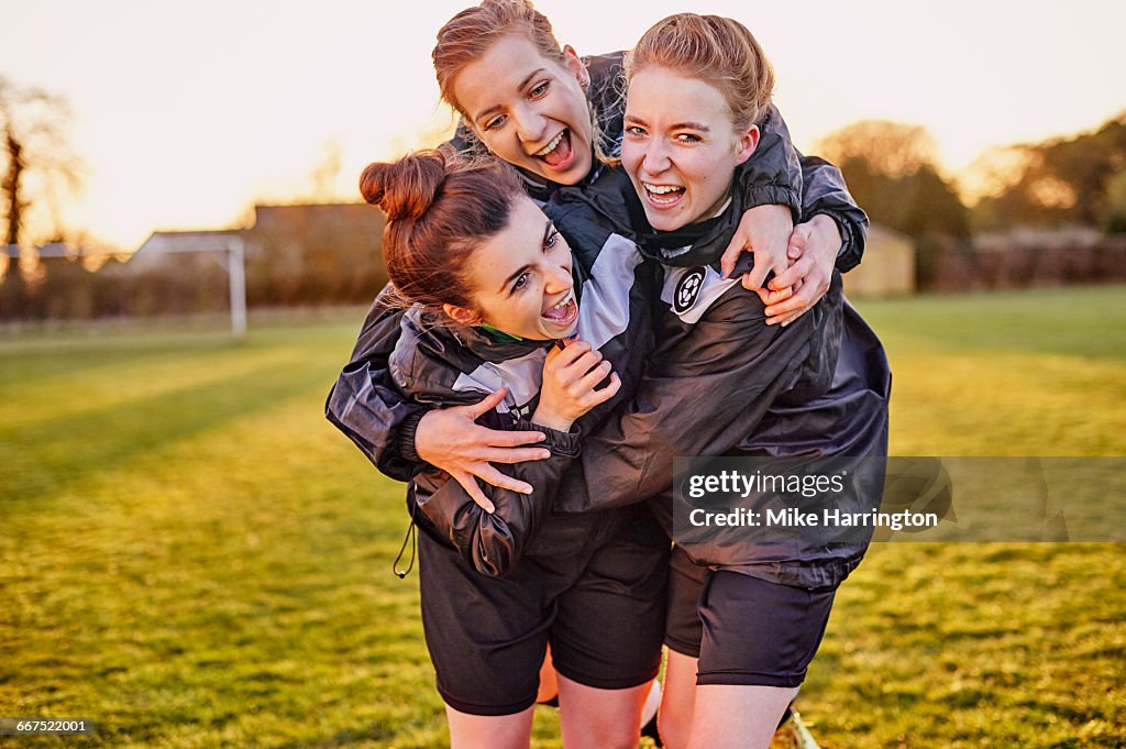 Group of female footballers embracing