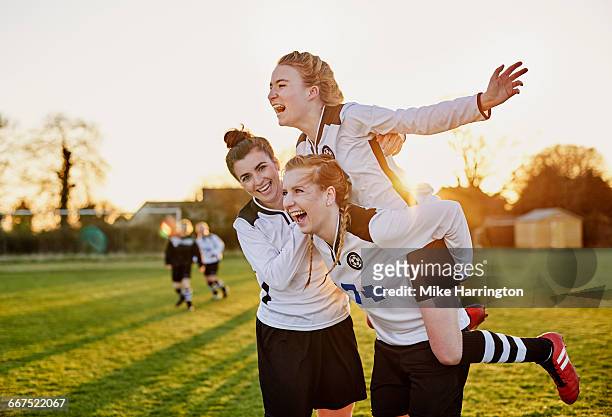 female footballers celebrating goal - 女子サッカー ストックフォトと画像