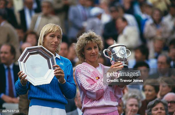 American tennis players Martina Navratilova and Chris Evert-Lloyd with the trophies, after Evert beat Navratilova to win the Women's Singles title at...