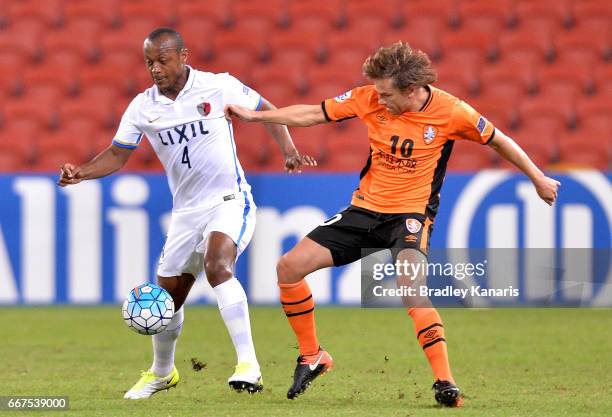 Leo Silva of the Antlers and Brett Holman of the Roar compete for the ball during the AFC Asian Champions League Group Stage match between the...