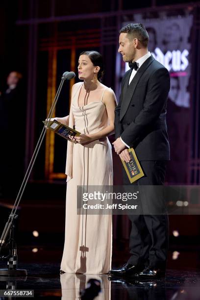 Phoebe Fox and Ben Forster present an award on stage during The Olivier Awards 2017 at Royal Albert Hall on April 9, 2017 in London, England.