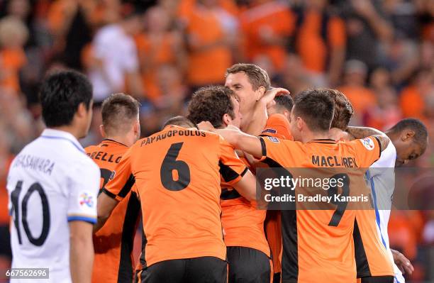 Brett Holman of the Roar celebrates with team mates after scoring a goal during the AFC Asian Champions League Group Stage match between the Brisbane...