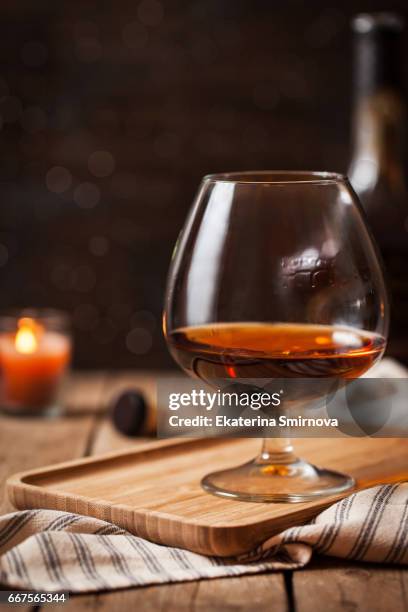 glass of cognac on dark background - grappa stockfoto's en -beelden