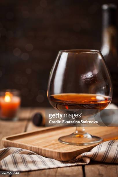 glass of cognac on dark background - grappa imagens e fotografias de stock