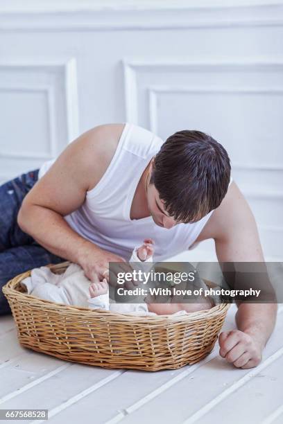 loving father holding newborn baby boy, father's day, man with infant child - father time stock pictures, royalty-free photos & images