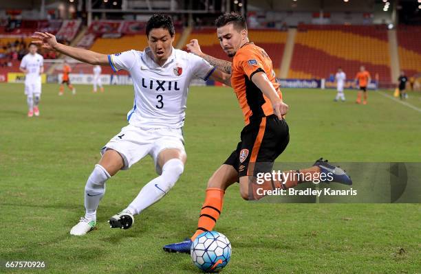 Jamie Maclaren of the Roar is challenged by Shoji Gen of the Antlers during the AFC Asian Champions League Group Stage match between the Brisbane...