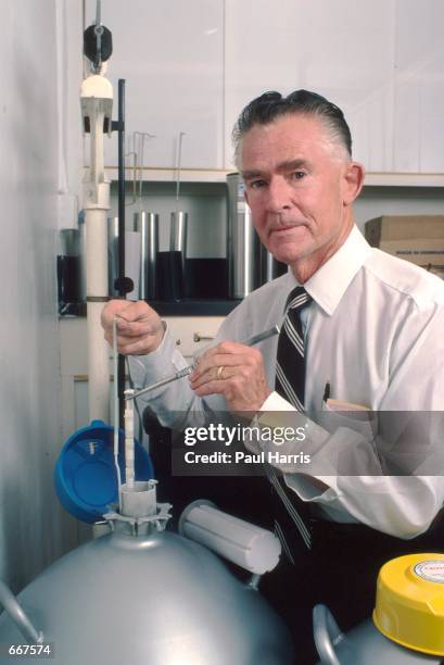 Dr Robert Graham founder of the Genius Sperm bank in San Diego. Photographed with a vial of sperm July 1982. Dr Graham provided the sperm to Dr Aftom...