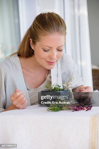 beautiful woman smelling fresh aroma herbs - aromatherapy stock-fotos und bilder