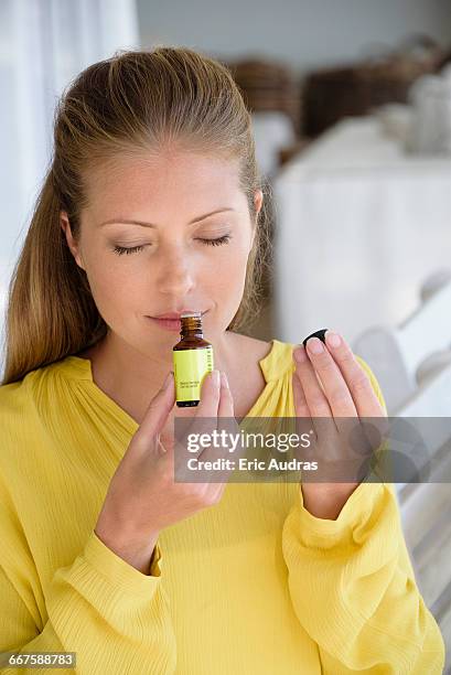 close-up of a woman smelling tea tree oil - tea tree stock pictures, royalty-free photos & images