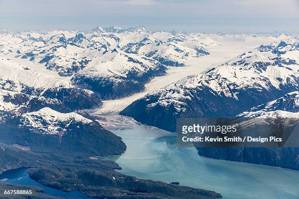 aerial view of a tidewater glacier in the inside passage, and snow capped peaks, wrangell, southeast alaska, usa, spring - inside passage stock pictures, royalty-free photos & images