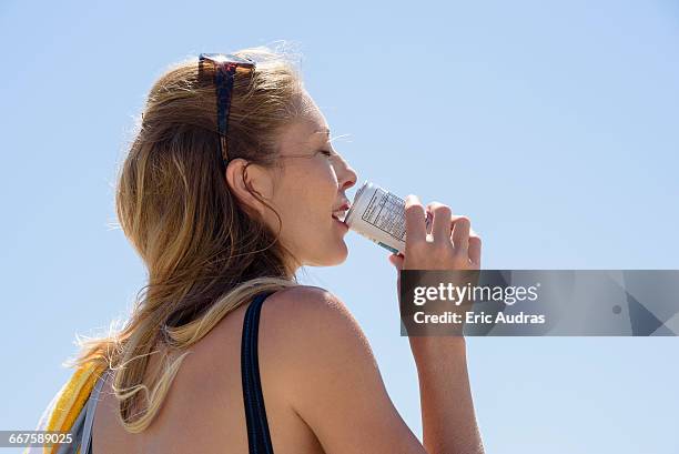 beautiful woman enjoying cold drink - 缶飲料 ストックフォトと画像