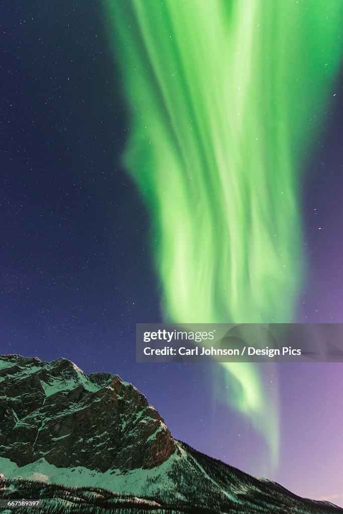 Aurora borealis display over Mt. Sukakpak in the Brooks Range near Wiseman, Alaska.
