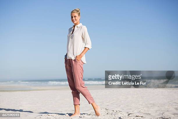 beautiful young woman walking on sunny beach - le sommer stock pictures, royalty-free photos & images