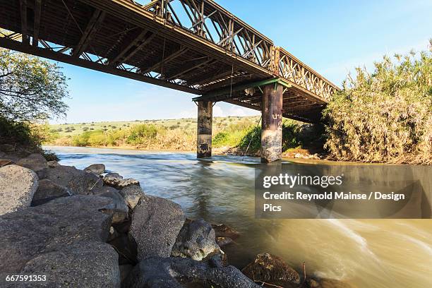 a bridge crossing over the jordan river - river jordan stock pictures, royalty-free photos & images