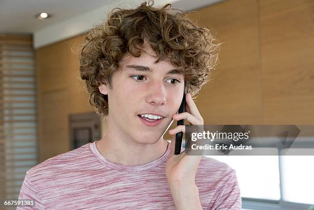 teenage boy talking on a mobile phone - one teenage boy only stock pictures, royalty-free photos & images