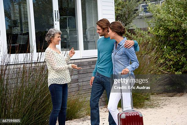 happy mature woman meet with young couple outside - introducing girlfriend stock pictures, royalty-free photos & images