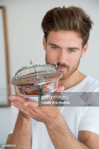 young man holding a model boat - toy boat stock pictures, royalty-free photos & images