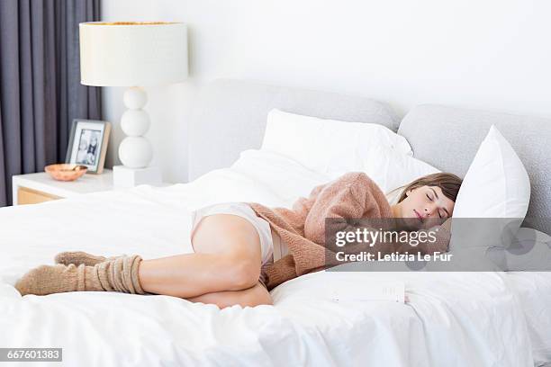 beautiful young woman sleeping on the bed - bedroom photos stock-fotos und bilder