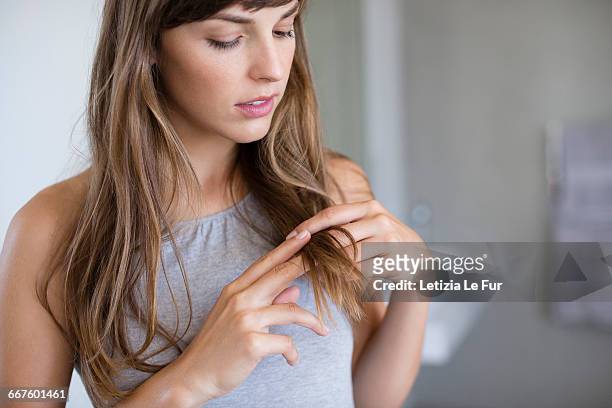 close-up of a woman adjusting her hair - human hair stockfoto's en -beelden