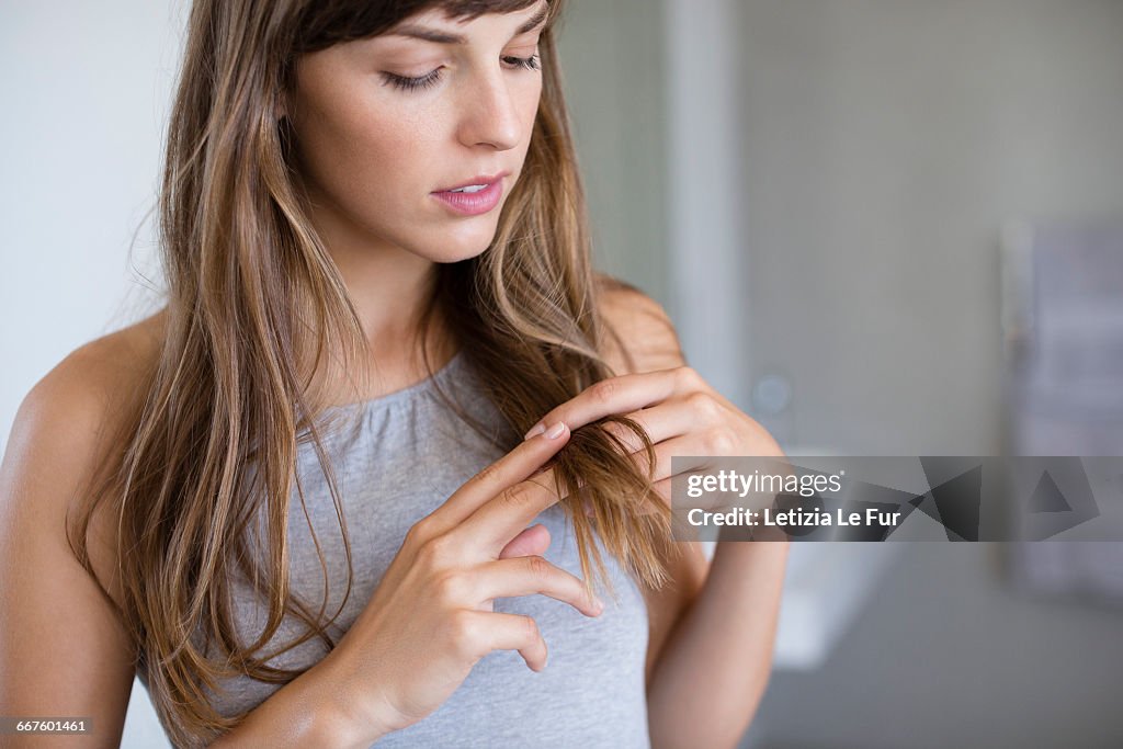 Close-up of a woman adjusting her hair