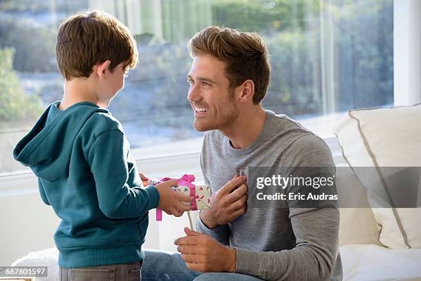 happy father and son with birthday gift - child giving gift ストックフォトと画像