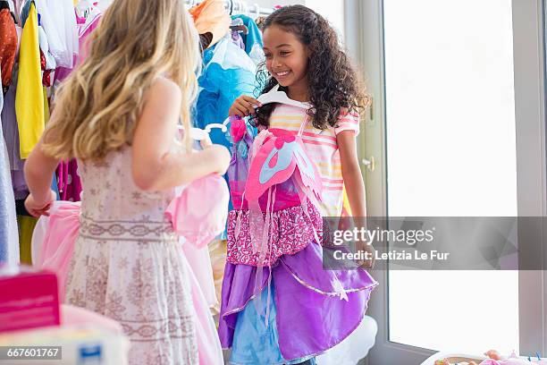 two little girls trying on clothes - dress fitting room stock pictures, royalty-free photos & images