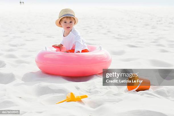 baby boy playing on the beach - beach bucket stock pictures, royalty-free photos & images
