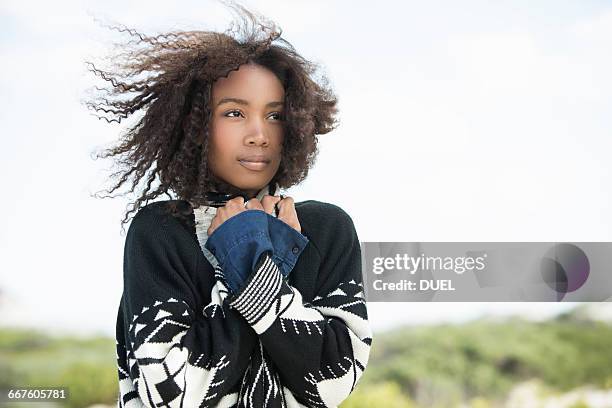 young woman feeling cold in wind - beef stockfoto's en -beelden