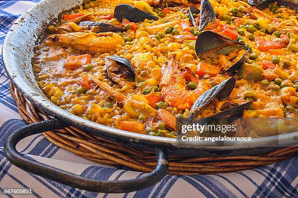 close-up of seafood paella - paella stock-fotos und bilder