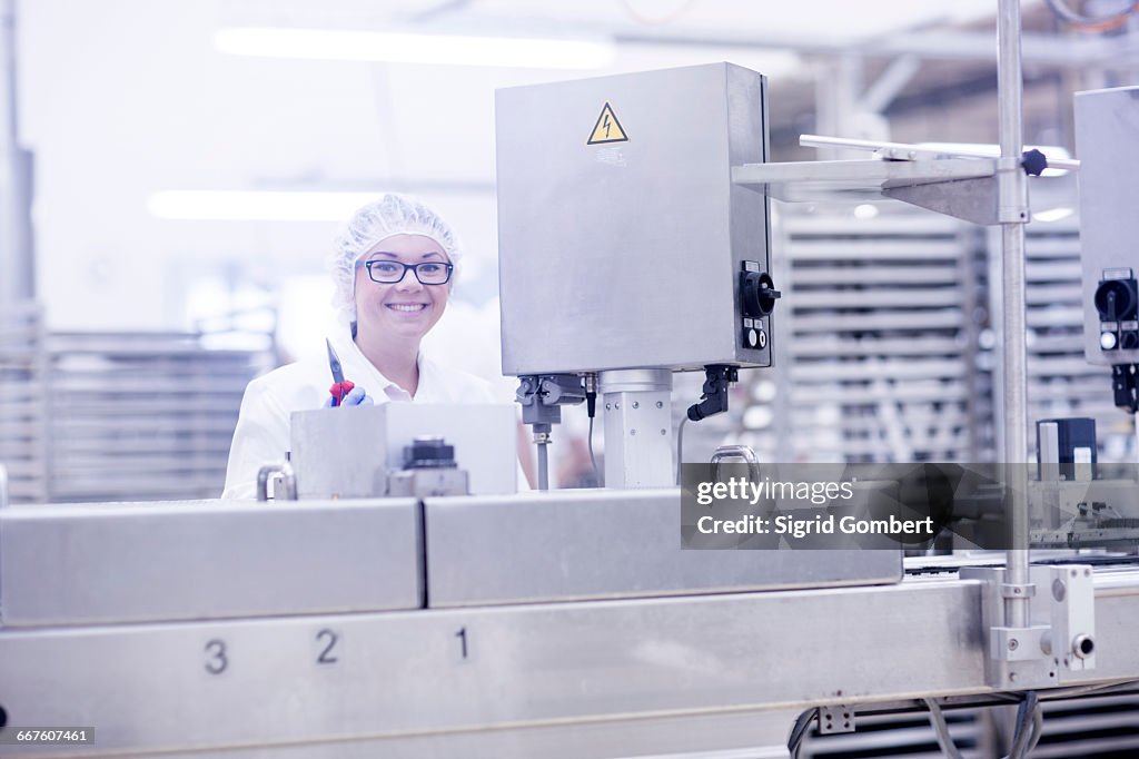 Factory worker operating food production machinery