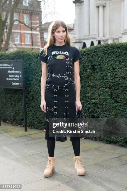 Fahsion writer and founder of hey-woman.com Veronika Heilbrunner wears a Christopher Kane dress and bag, Acne boots and a Metallica t-shirt on day 4...