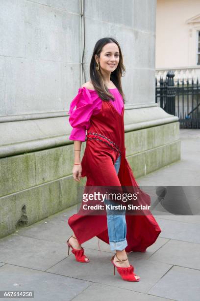 Junior fashion editor at Harpers Bazaar UK Anna Vitiello wears a Rejina Pyo top, DKNY dress, vintage jeans and Malone Souliers shoes on day 4 of...
