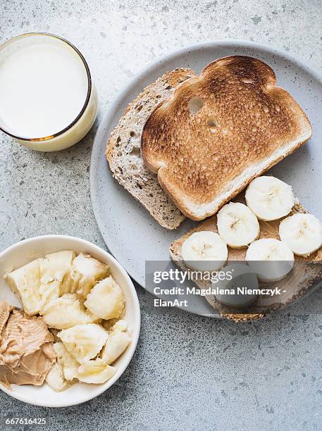 overhead view of toast with peanut butter, banana and milk - peanut butter toast stock pictures, royalty-free photos & images