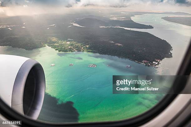 aerial photo shot from plane flying from bali to singapore - plane windows stock pictures, royalty-free photos & images
