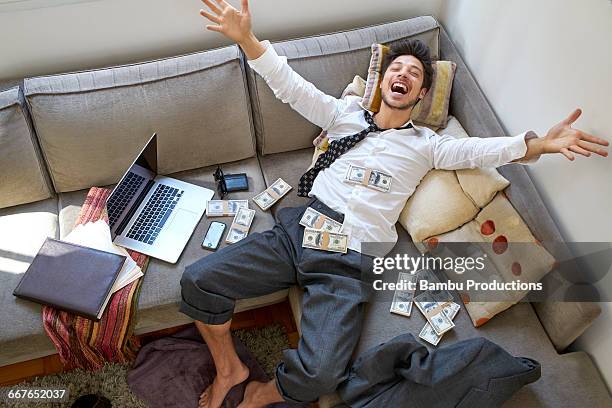 man bursting with joy with lots of money - wealth abundance stock pictures, royalty-free photos & images