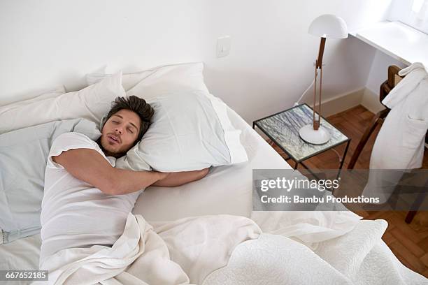 up view of man sleeping in bed - men in bed stock-fotos und bilder