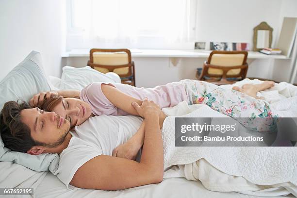 woman and man embracing in bed - 30 34 years stock illustrations