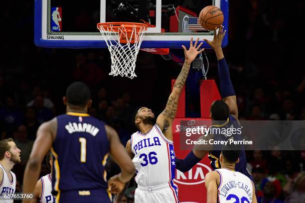 Shawn Long of the Philadelphia 76ers defends against Lavoy Allen of the Indiana Pacers during the second quarter at the Wells Fargo Center on April...