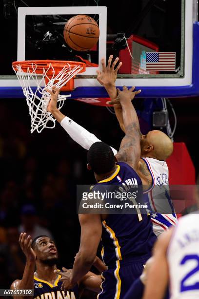Kevin Seraphin of the Indiana Pacers defends against Gerald Henderson of the Philadelphia 76ers as Thaddeus Young of the Indiana Pacers looks on...