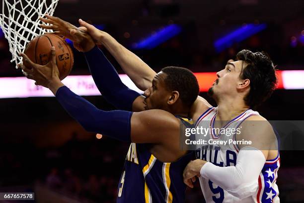 Lavoy Allen of the Indiana Pacers is defended by Dario Saric of the Philadelphia 76ers during the fourth quarter at the Wells Fargo Center on April...