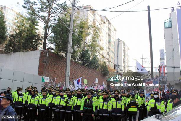 Supporters of ousted South Korean President Park Geun-hye sit in front of her private home on March 30, 2017 in Seoul, South Korea. A hearing to...