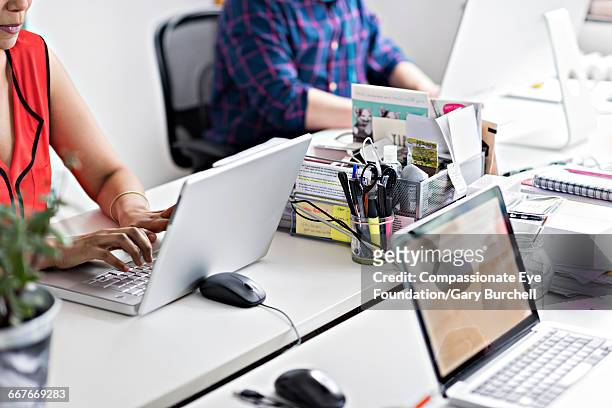 business people working in tech start-up office - gary burchell stock pictures, royalty-free photos & images