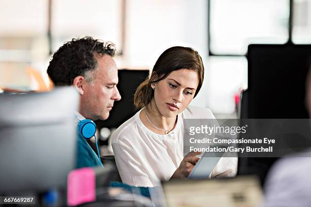 business people working in tech start-up office - gary burchell stock pictures, royalty-free photos & images