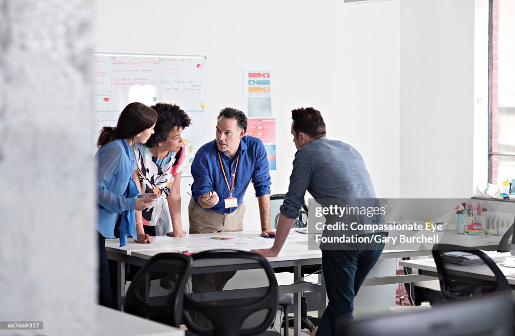 Colleagues brainstorming in tech start-up office