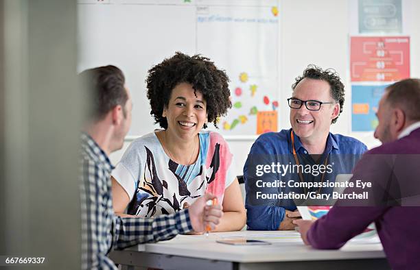 colleagues brainstorming in tech start-up office - gary burchell stock pictures, royalty-free photos & images