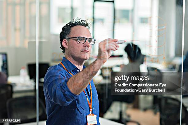 businessman working in tech start-up office - gary burchell stock pictures, royalty-free photos & images