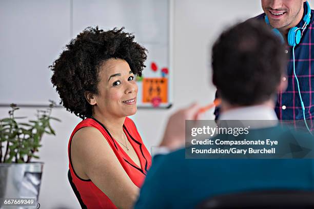 colleagues brainstorming in tech start-up office - gary burchell stock pictures, royalty-free photos & images