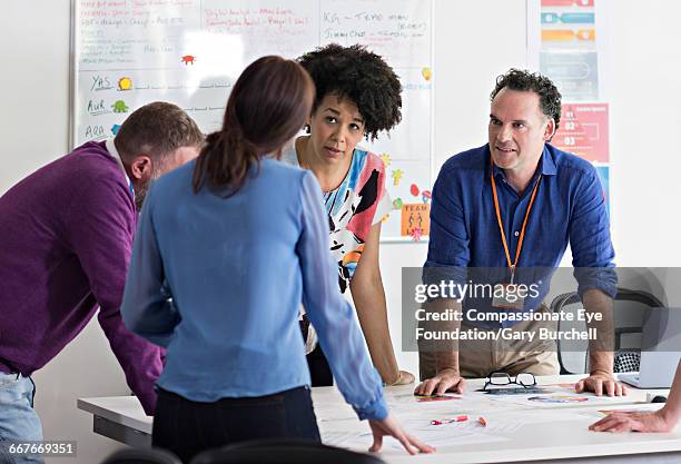 colleagues brainstorming in tech start-up office - gary burchell stock pictures, royalty-free photos & images